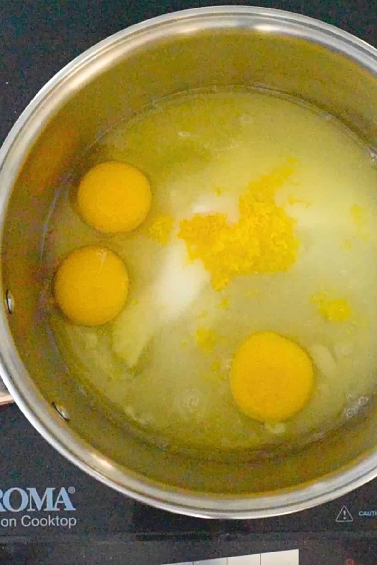 ingredients in lemon curd in saucepan.