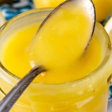 jar of lemon curd with spoon resting on it