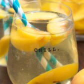 peach sangria in stemless wine glass