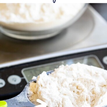 measuring cup with flour in it and scale behind with words on photo