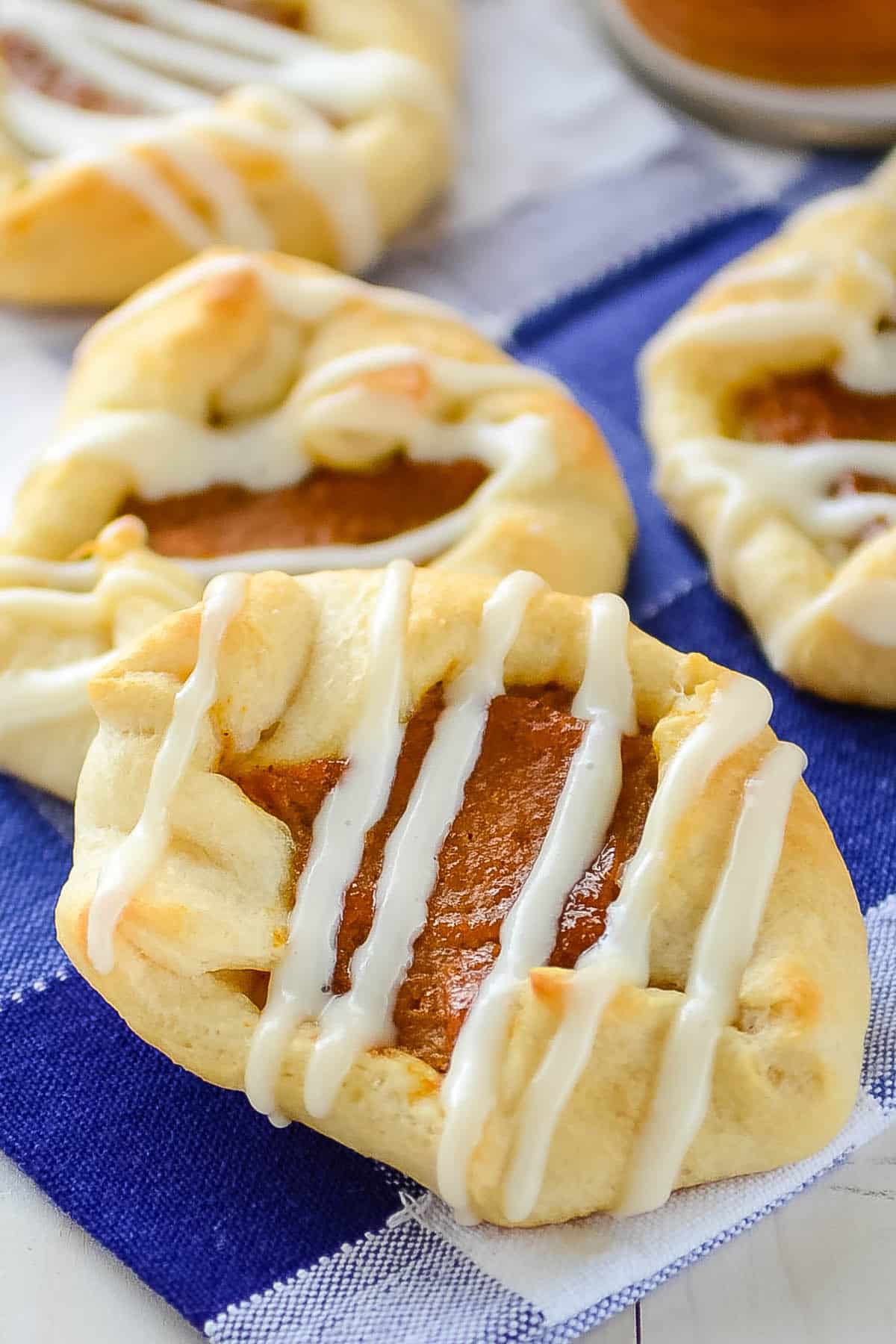 crescent roll with pumpkin inside and drizzle