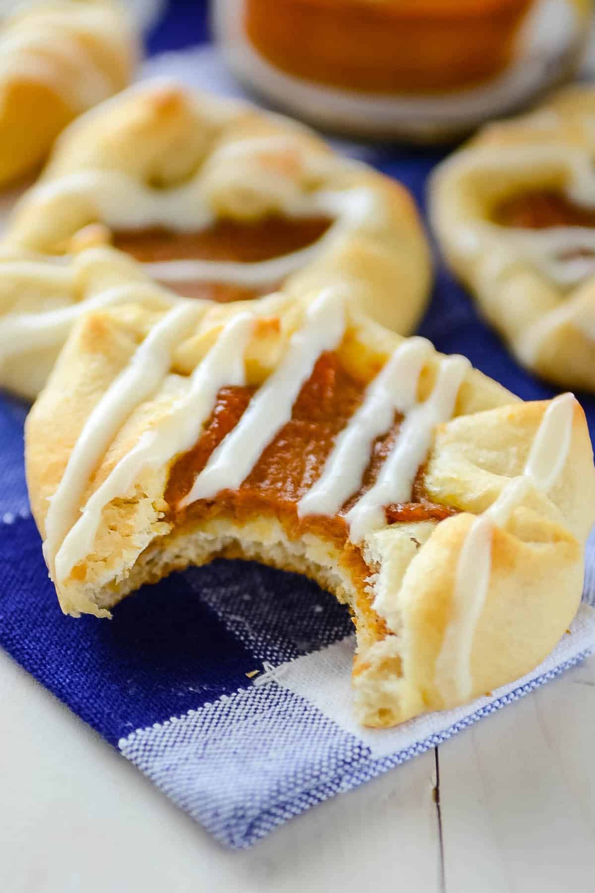 crescent roll with pumpkin inside and drizzle