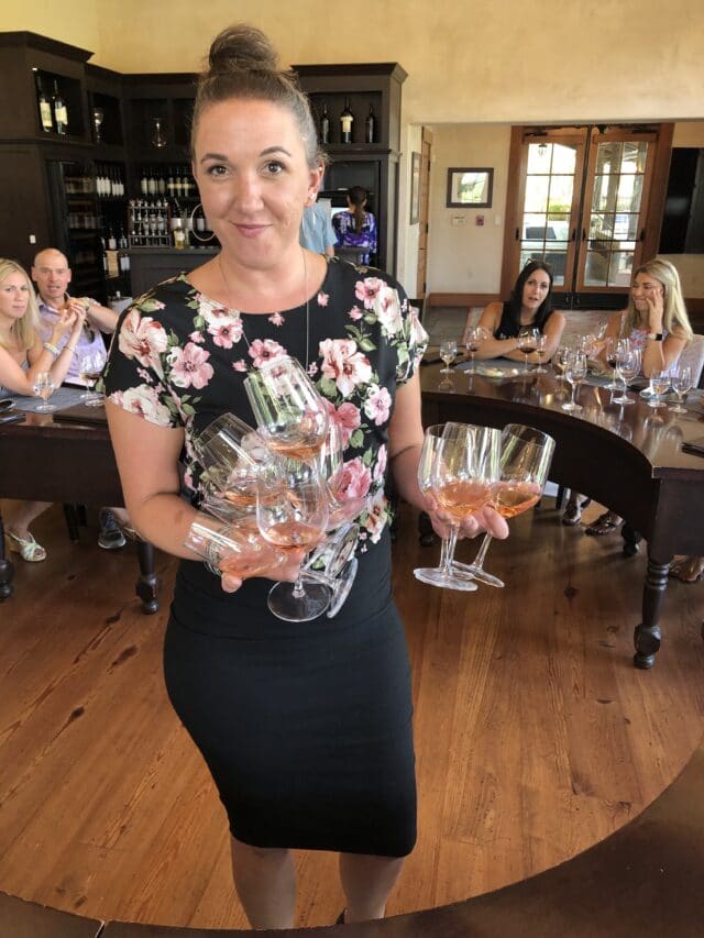 woman holding wine glasses