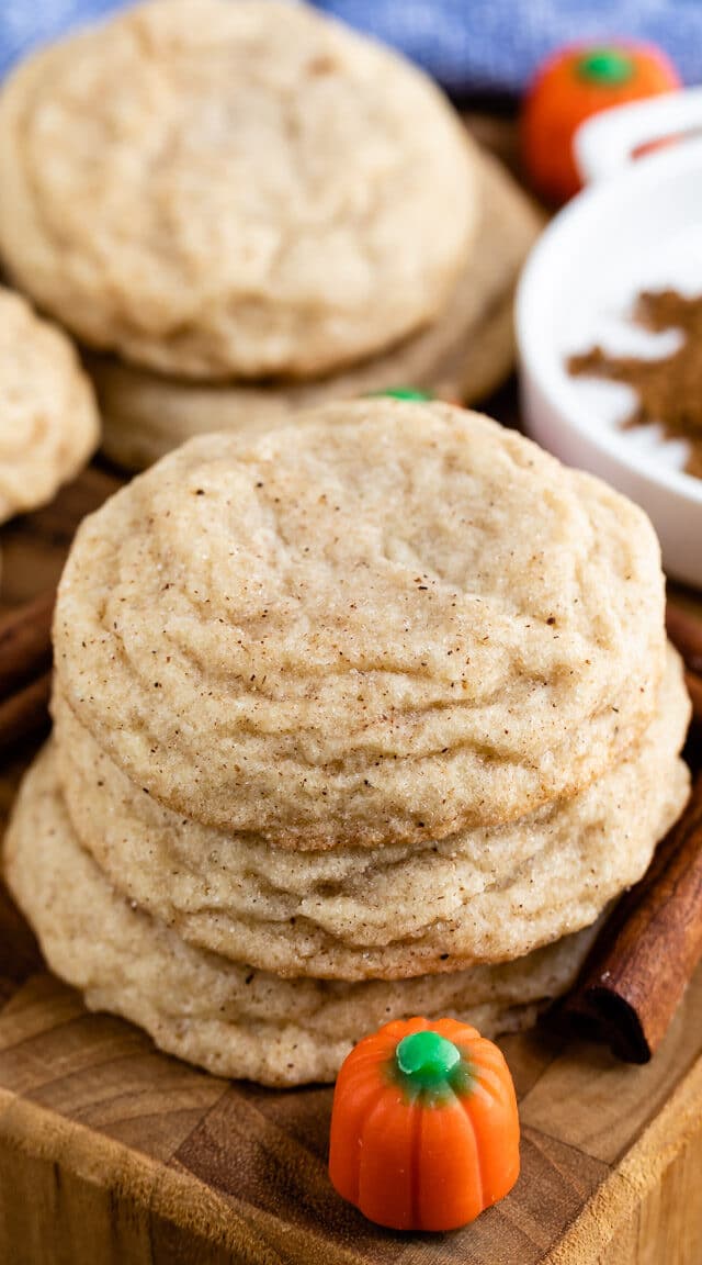 stack of snickerdoodles with pumpkin pie spice behind