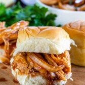 spicy pulled chicken sandwich on cutting board