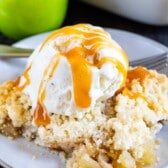 apple crisp on plate with ice cream and caramel