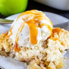 apple crisp on plate with ice cream and caramel