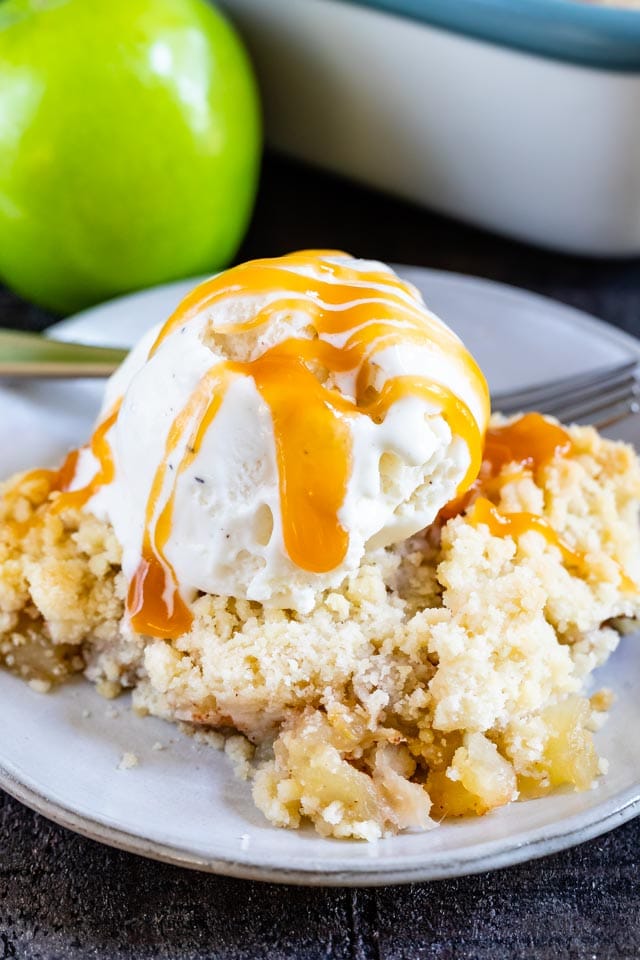 apple crisp on plate with ice cream and caramel