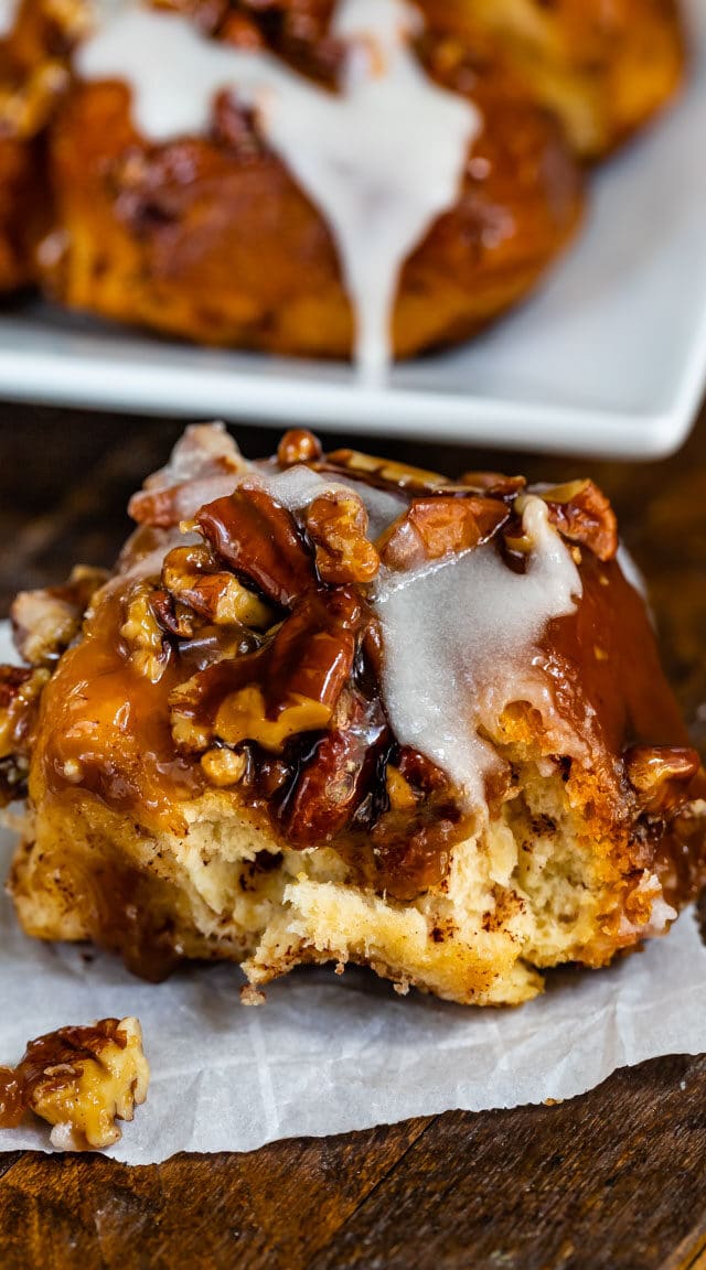 sticky bun with icing on parchment