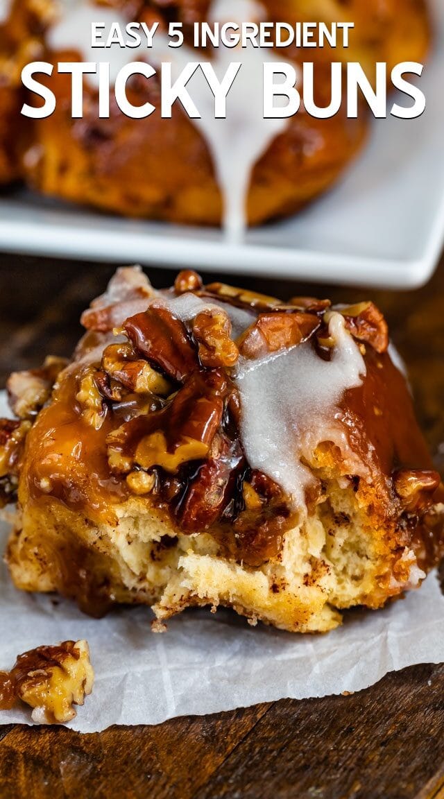 sticky bun with icing on a white plate