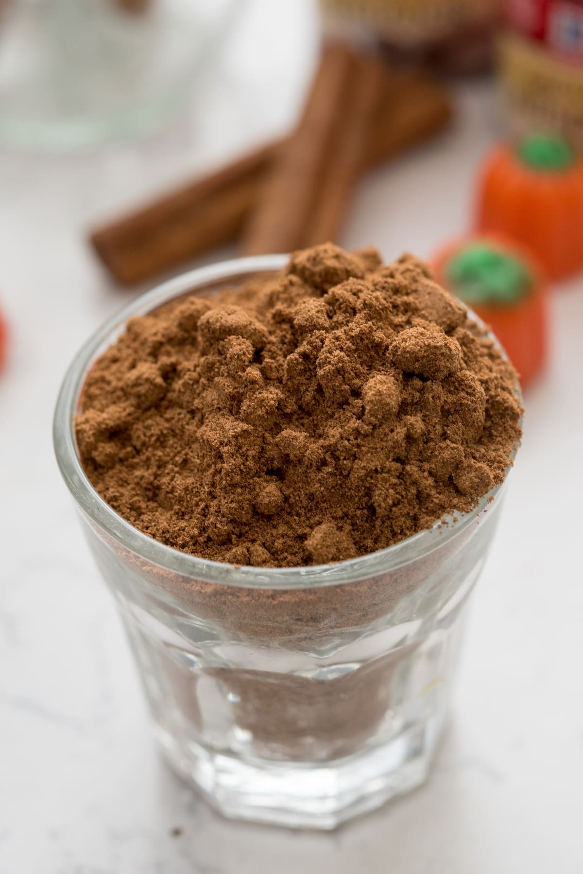 spices in shot glass on marble background