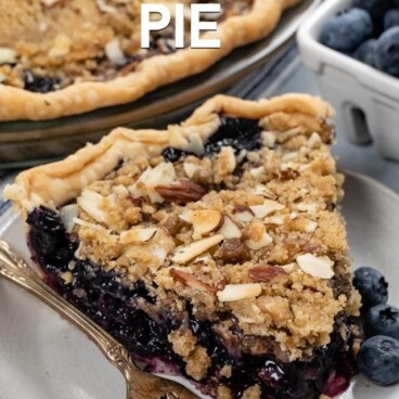 slice of blueberry crumble pie on white plate