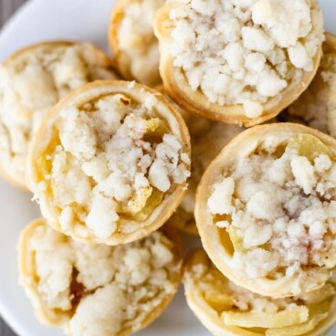 overhead shot of apple pies on white plate