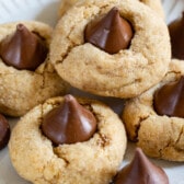 close up of peanut butter blossoms on white plate