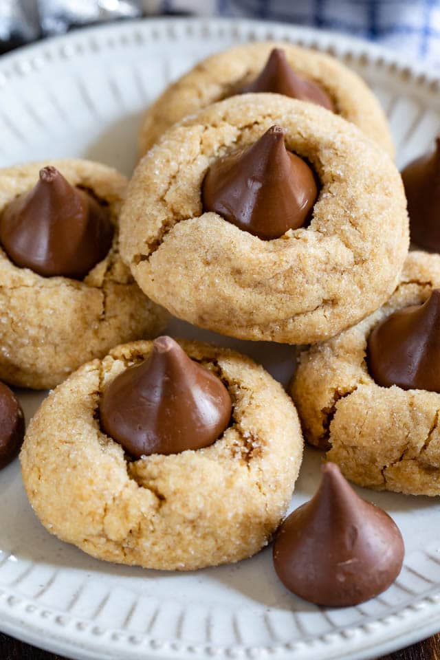 close up of peanut butter blossoms on white plate