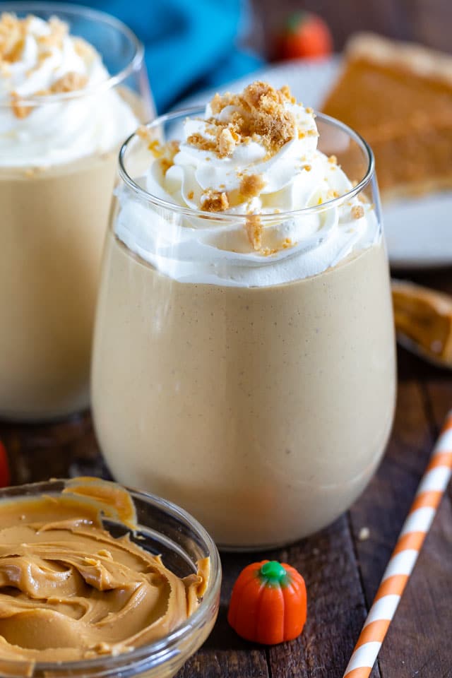 peanut butter smoothie in glass with whipped cream