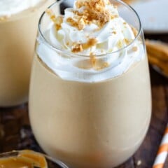 peanut butter smoothie in glass with whipped cream