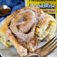 pumpkin spice cinnamon roll on white plate