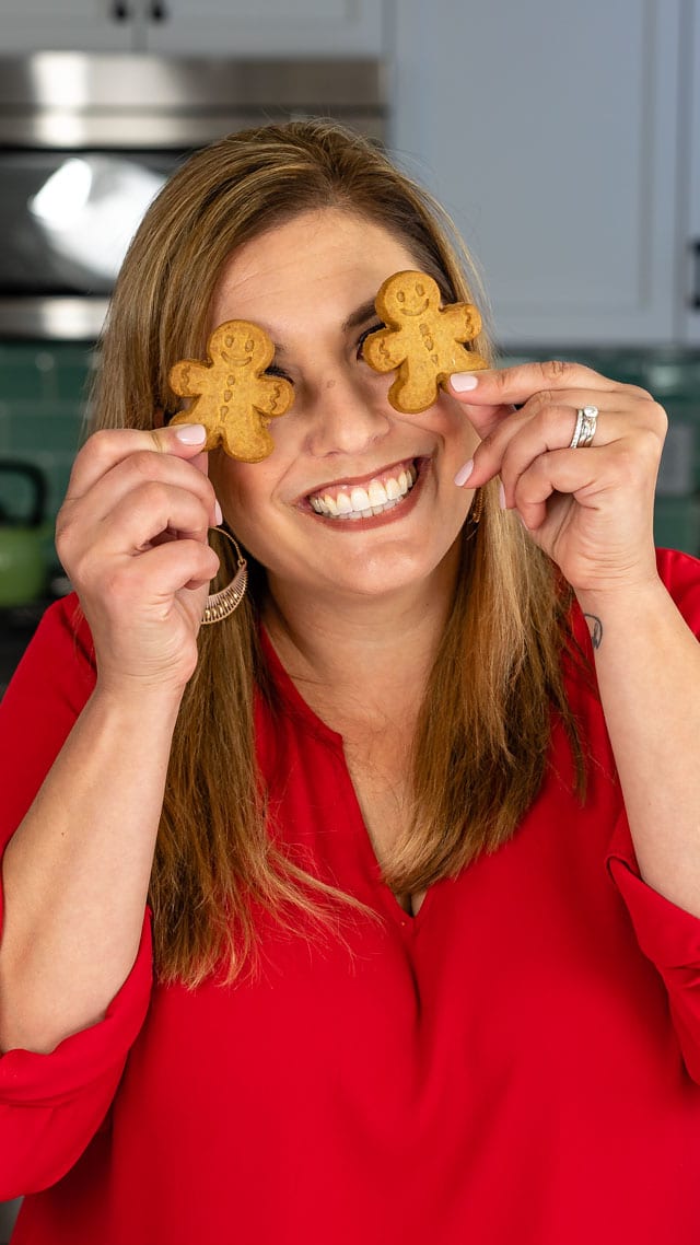 woman holding gingerbread cookies