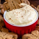 eggnog dip in red bowl with gingerbread men