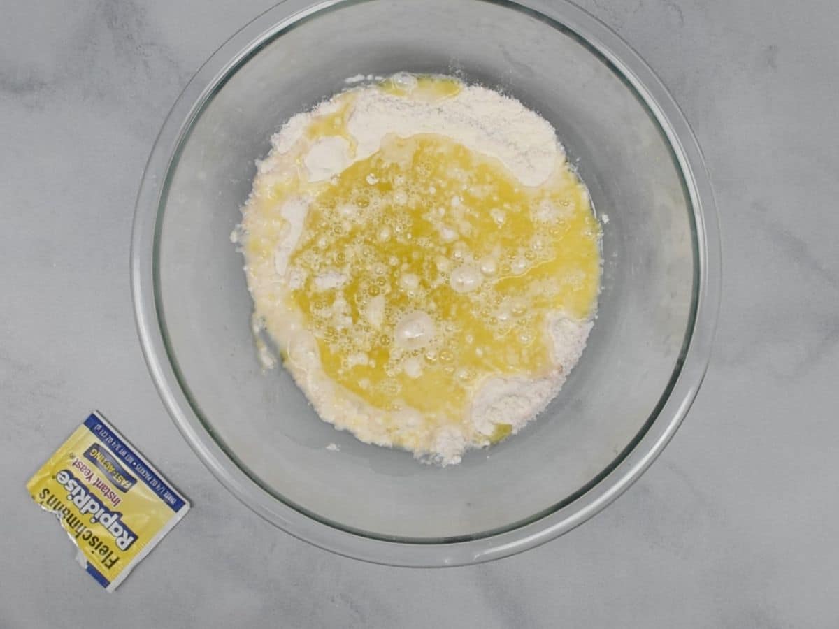 Dry ingredients with wet ingredients in glass bowl.