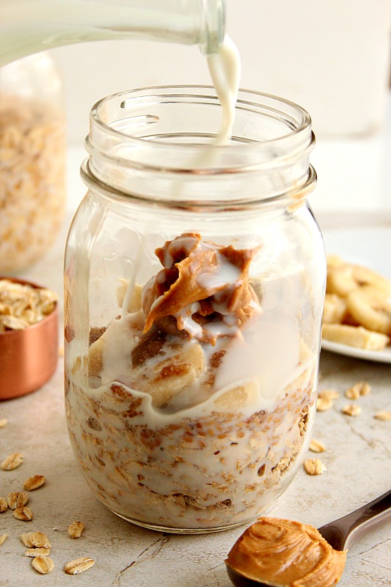 Peanut butter overnight oats in a mason jar with milk added