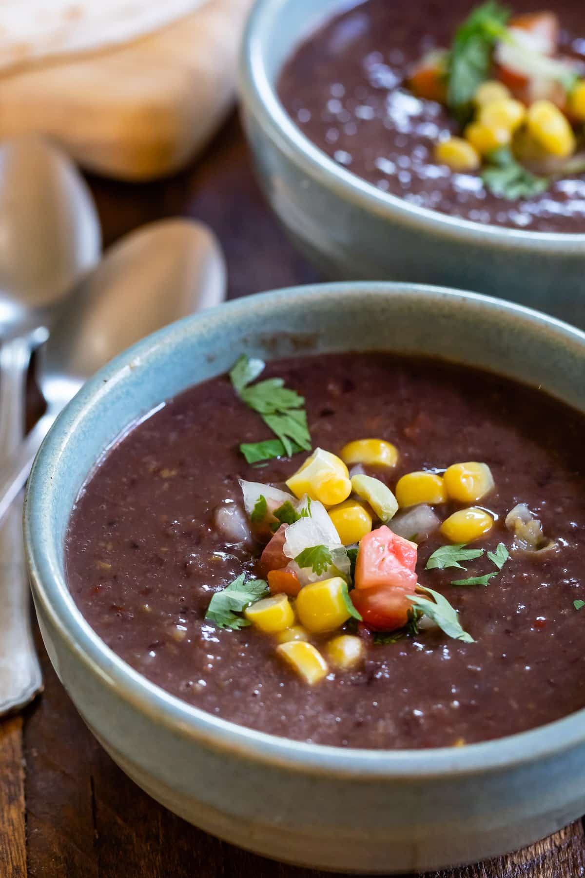 soup in blue bowl with corn on top.