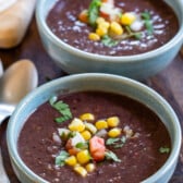 soup in blue bowl with corn on top.