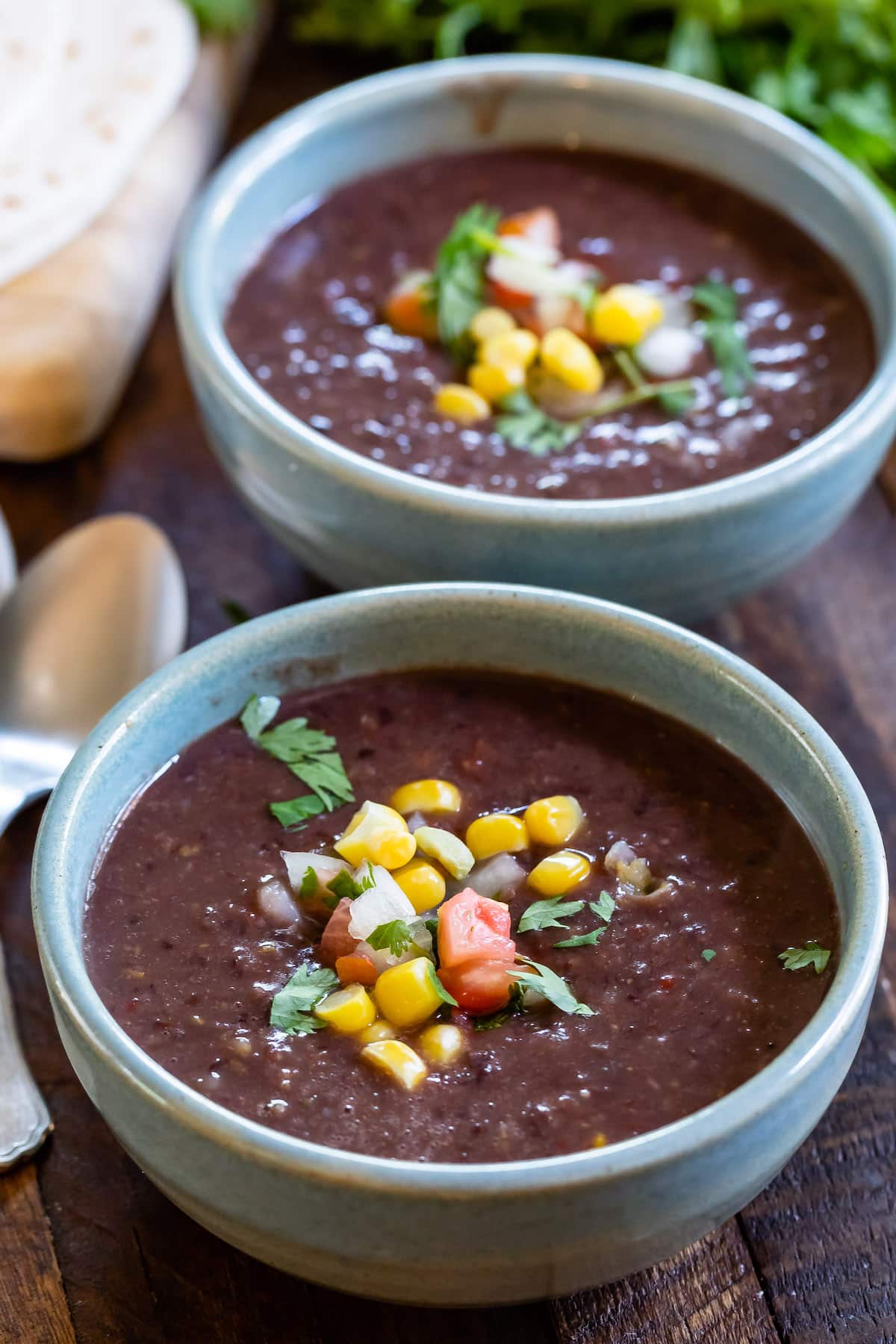 soup in blue bowl with corn on top.