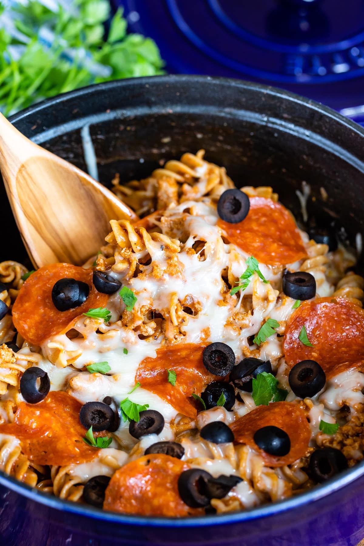 photo showing pasta in blue pot with pizza toppings