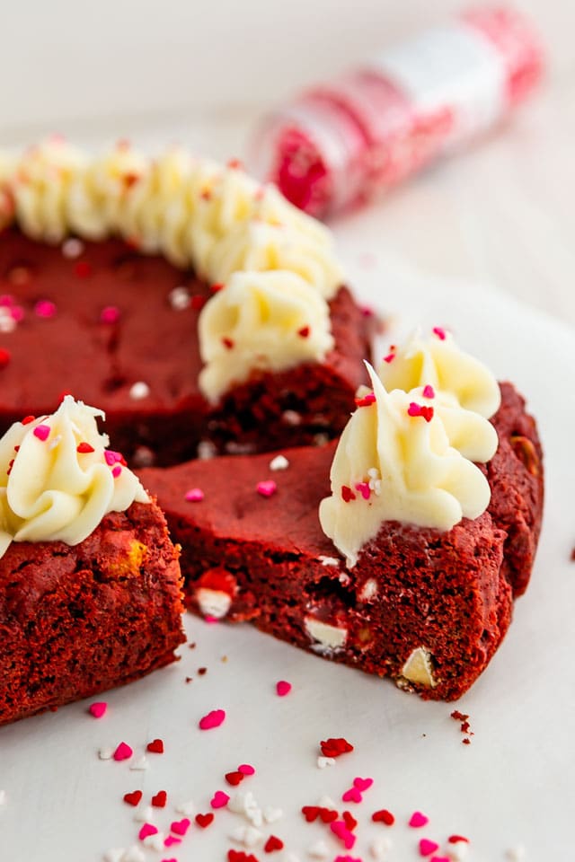 Slice of red velvet cookie cake with sprinkles