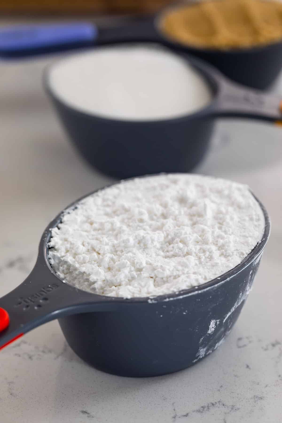 measuring cup with powdered sugar