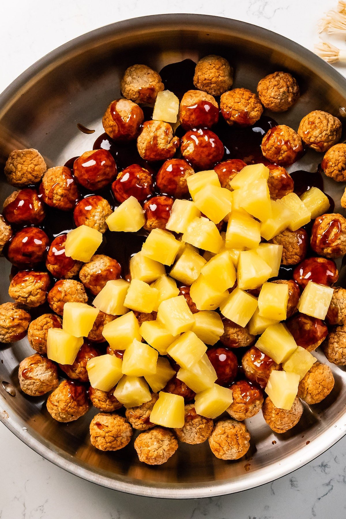 meatballs in pan with pineapple