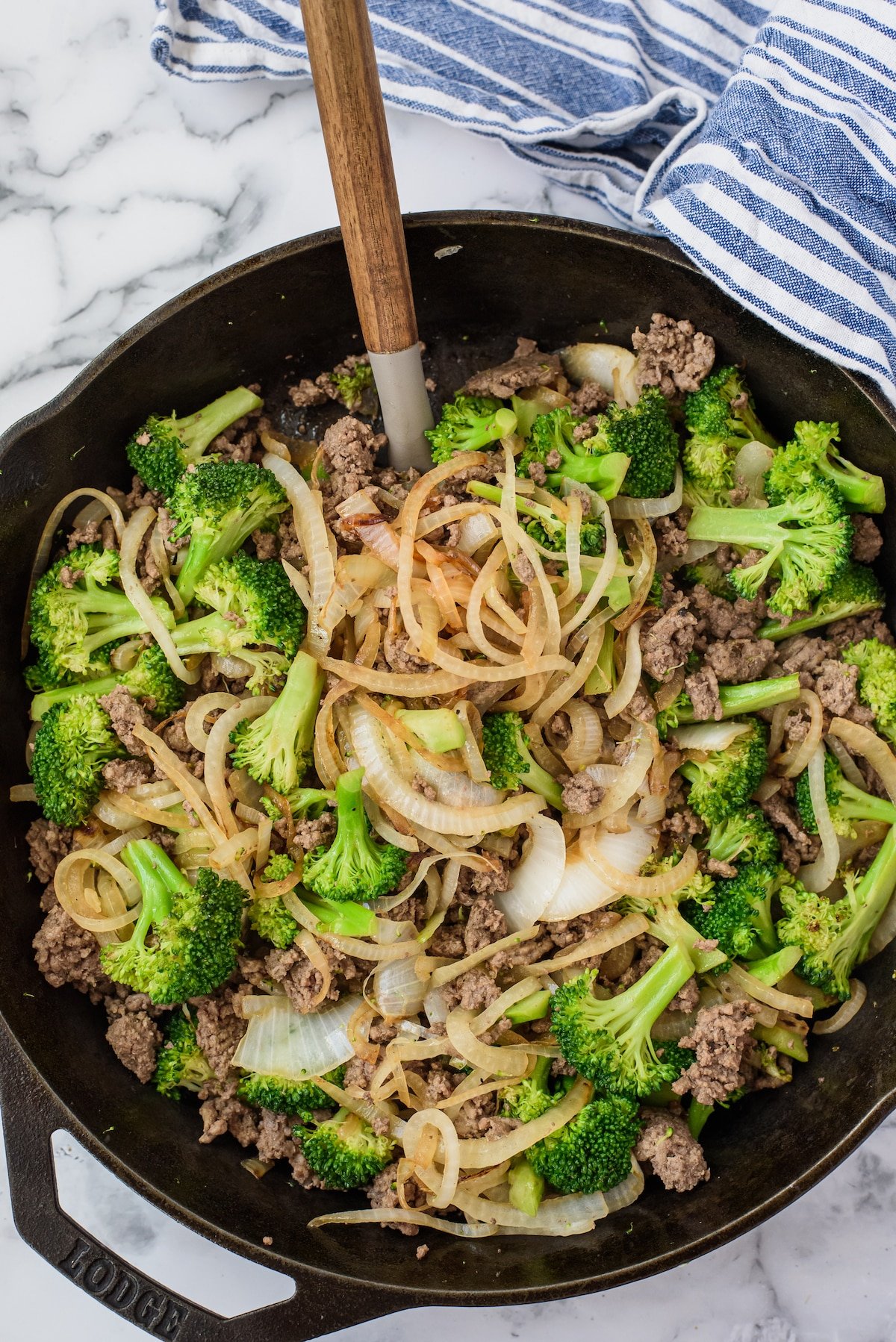 beef, broccoli and other things mixed together in a black pan