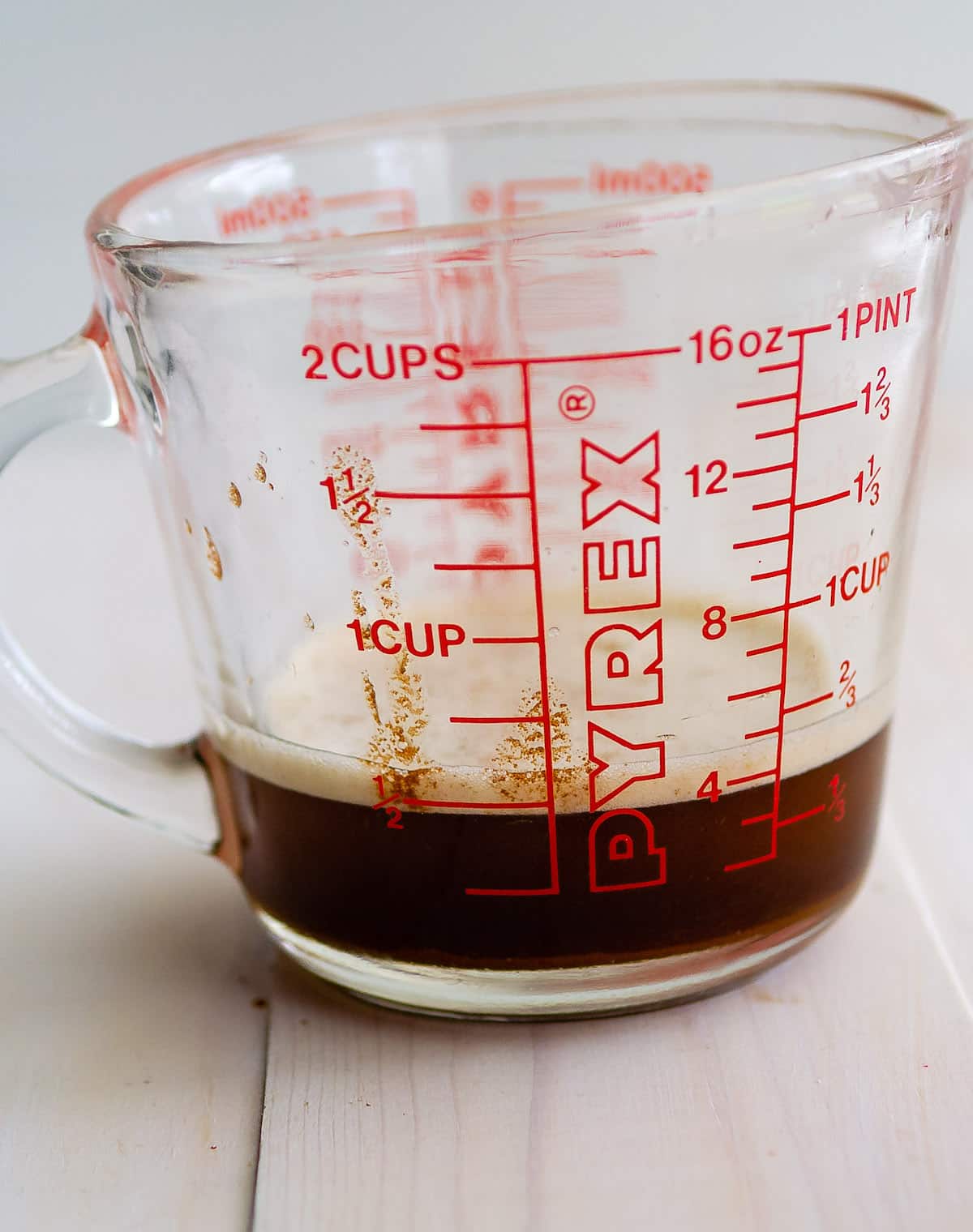 measuring cup with brown butter in it