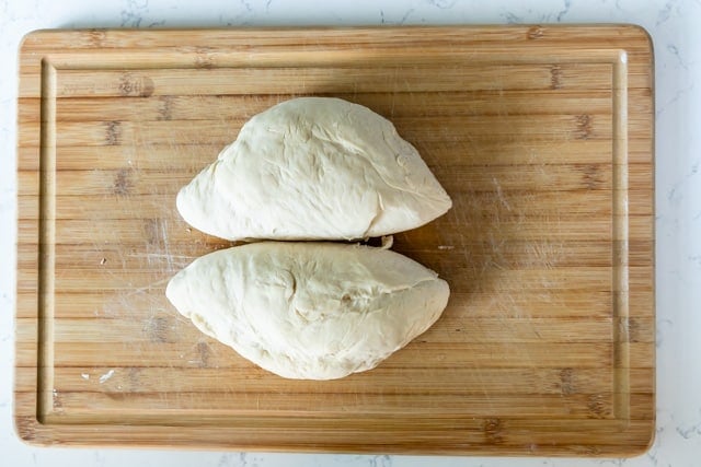 two dough loaves on cutting board
