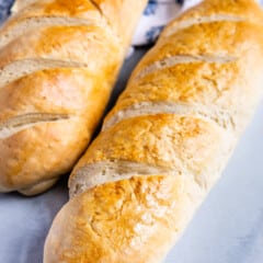 2 loaves of french bread with napkin behind