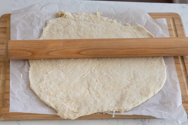 Easy pizza dough being rolled out