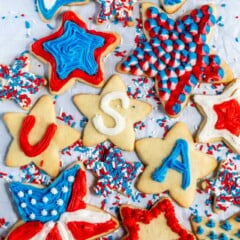 overhead shot of star shaped sugar cookies decorated with red, white and blue frosting