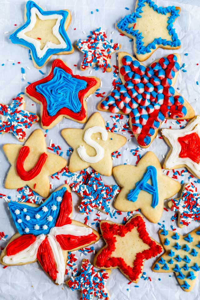 overhead shot of star shaped sugar cookies decorated with red, white and blue frosting