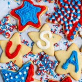 overhead shot of star shaped sugar cookies decorated with red, white and blue frosting