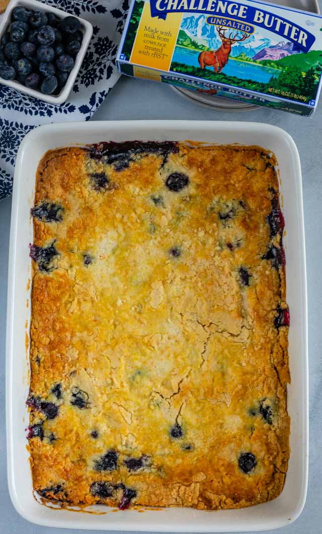 overhead shot of full blueberry cobbler in pan with challenge butter box