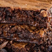 Brown butter brownies stack of three with text on top of photo