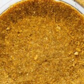 Overhead shot of graham cracker crust with recipe title on top of image