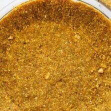 Overhead shot of graham cracker crust with recipe title on top of image