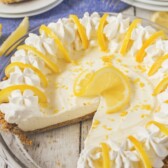 No bake lemon pie in a glass pie dish with one slice missing