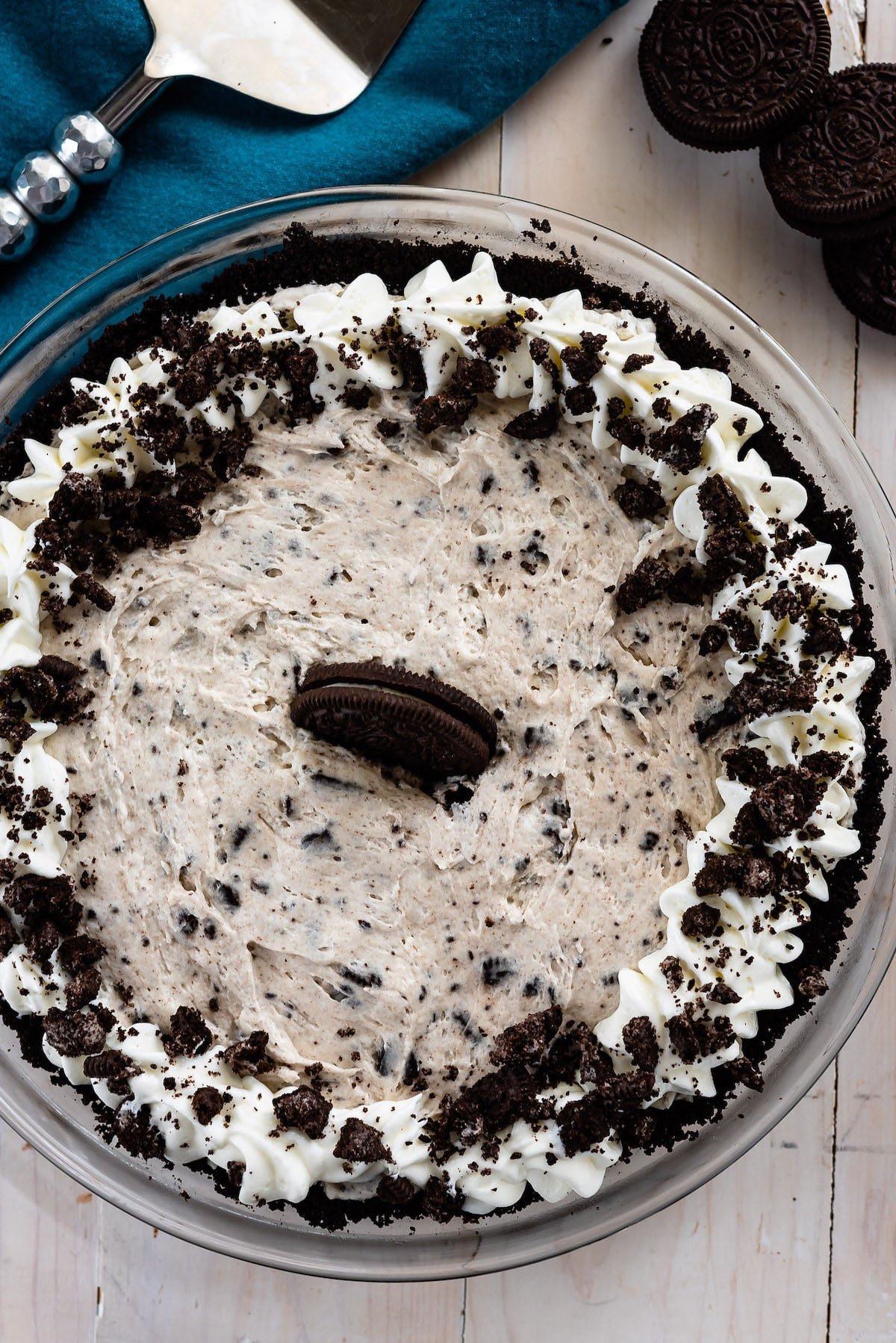 oreo cheesecake in pie plate with blue napkin behind.