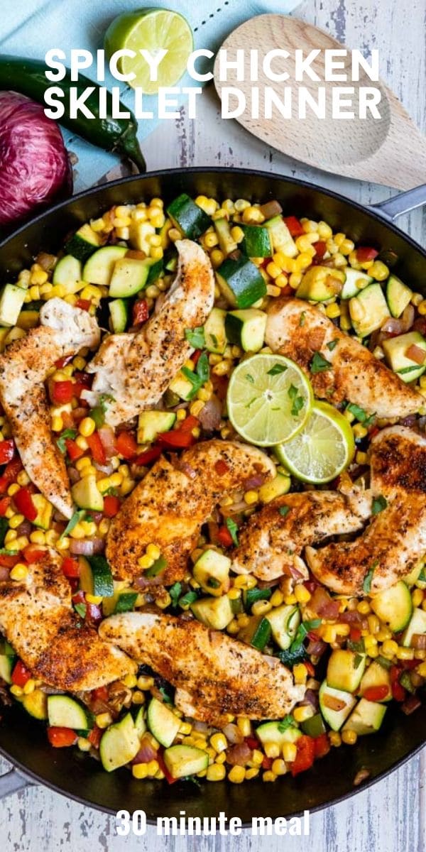 Overhead shot of spicy chicken dinner in black skillet with ingredients around and recipe title on top of photo