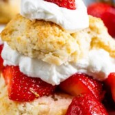 Biscuit strawberry shortcake on white plate with words on photo