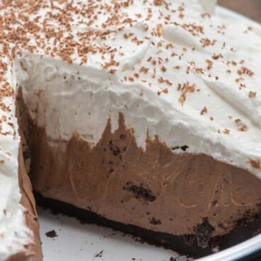 close up of chocolate cream pie with slice missing